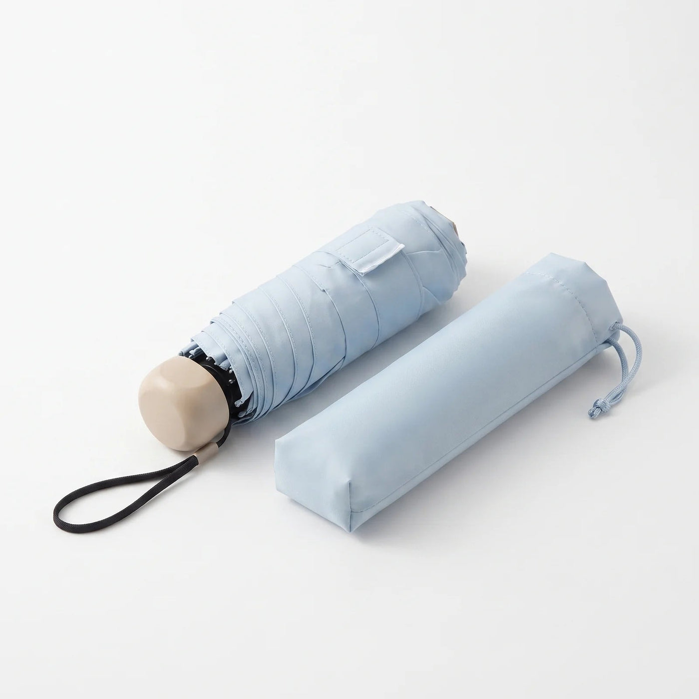 Umbrellys pocket umbrella, folded, with its storage sleeve